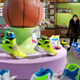 In this Friday, Feb. 1, 2019, photo, a guide stands near a basketball shoe display in a product exhibition room at the Ryuwon Shoe Factory that specializes in sports footwear, in Pyongyang, North Korea. North Korean pop culture, long dismissed by critics as a kitschy throwback to the dark days of Stalinism, is getting a major upgrade under leader Kim Jong Un. The changes are being seen in everything from television dramas and animation programs to the variety and packaging of consumer goods, which have improved significantly under Kim. (AP Photo/Dita Alangkara)